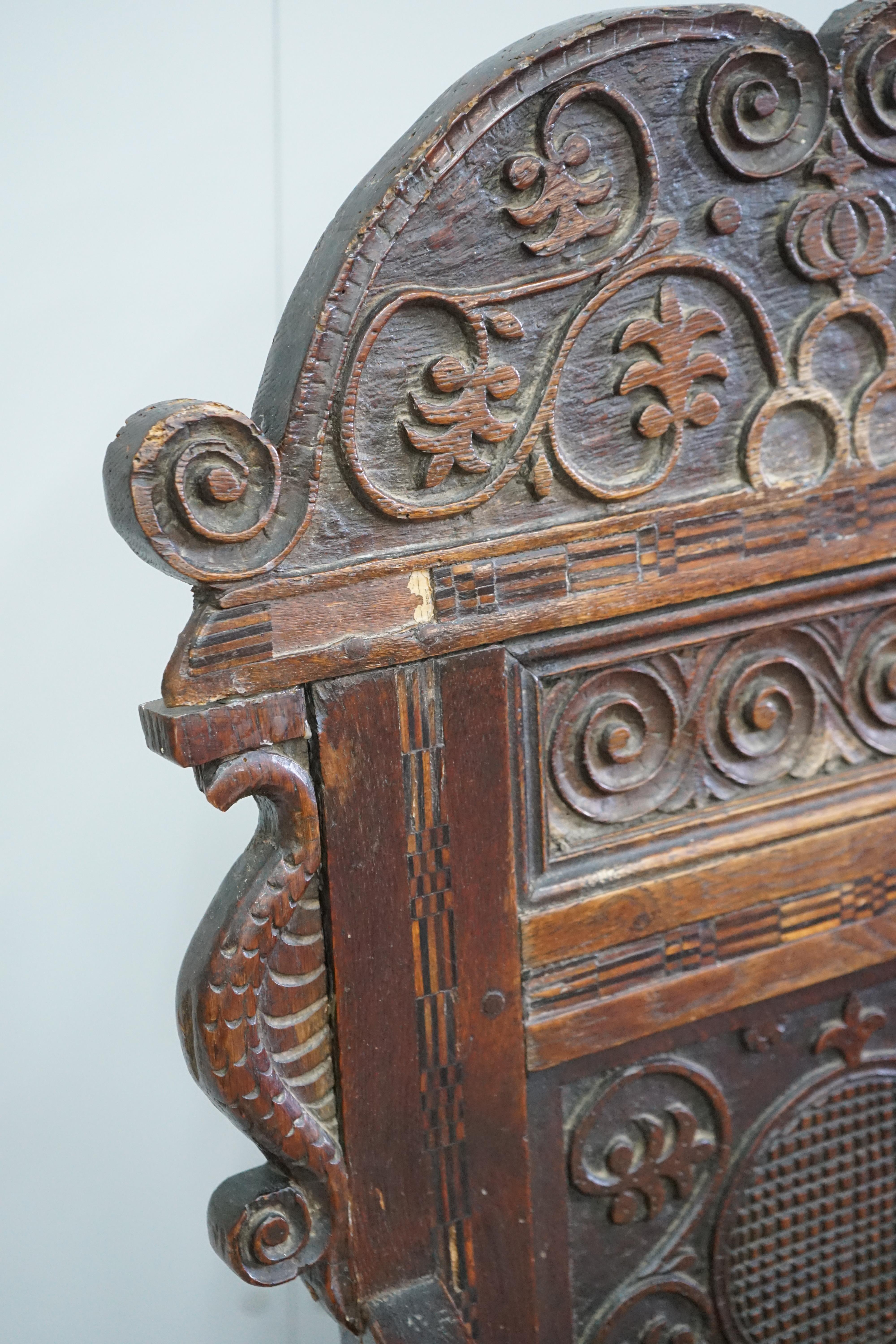 A pair of 17th century style inlaid panelled oak wainscot chairs, width 57cm, depth 40cm, height 121cm